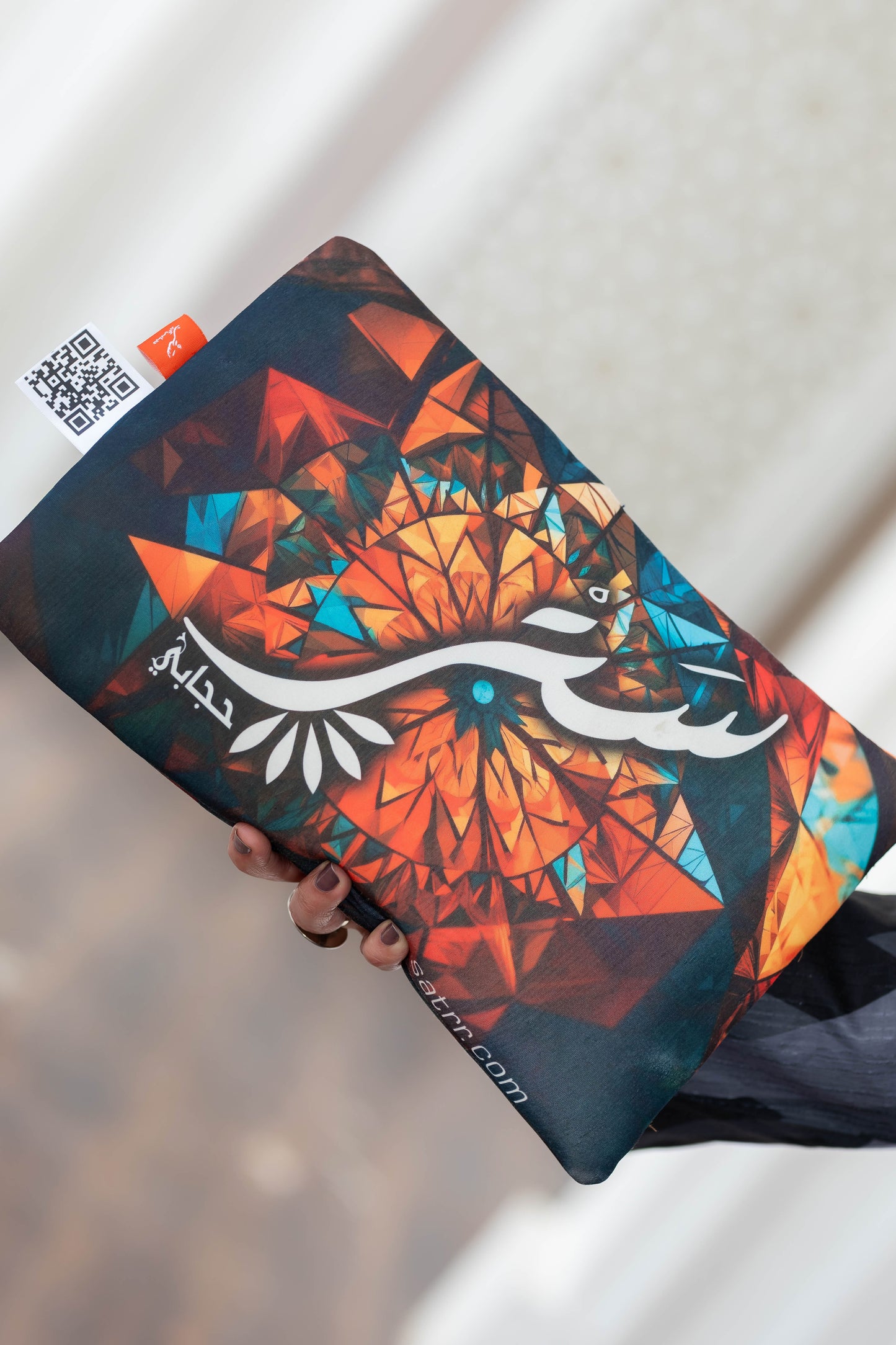 Vibrant geometric clutch bag with abstract floral design