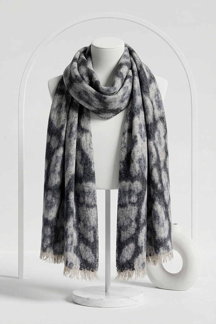 Gray patterned scarf on a mannequin against a white background