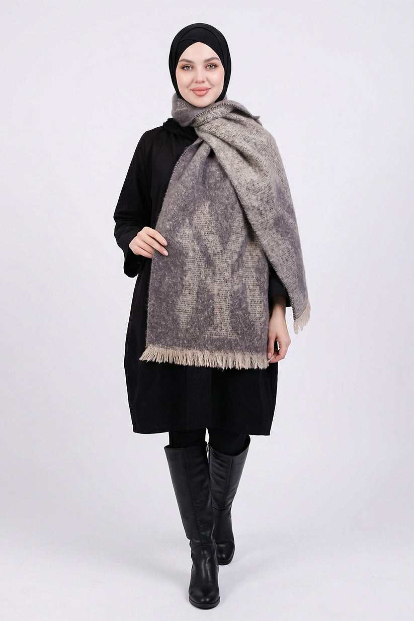 Woman wearing a large gray patterned scarf on a white background