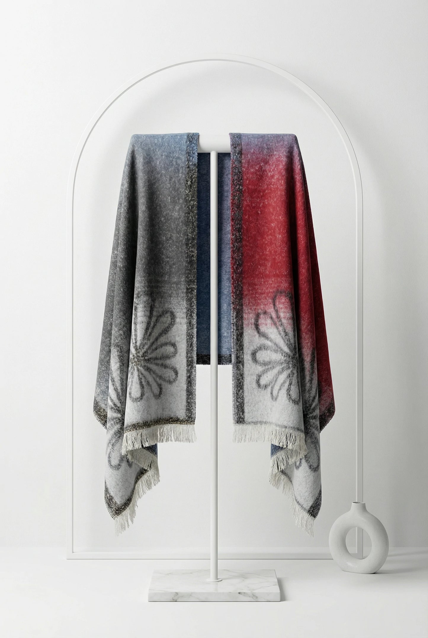 Two patterned scarves hanging on a white coat rack against a white background