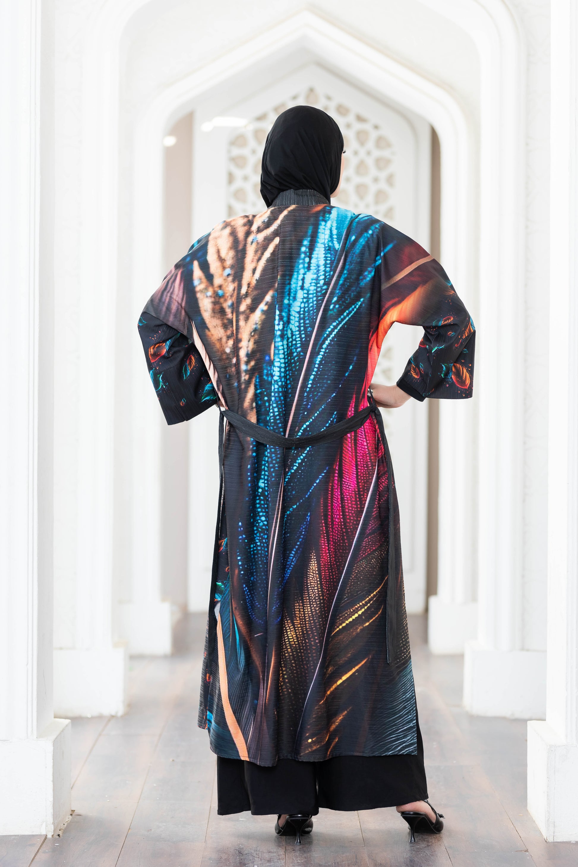 Colorful digital print kimono with vibrant patterns and textures, worn by a person in front of a white architectural design.