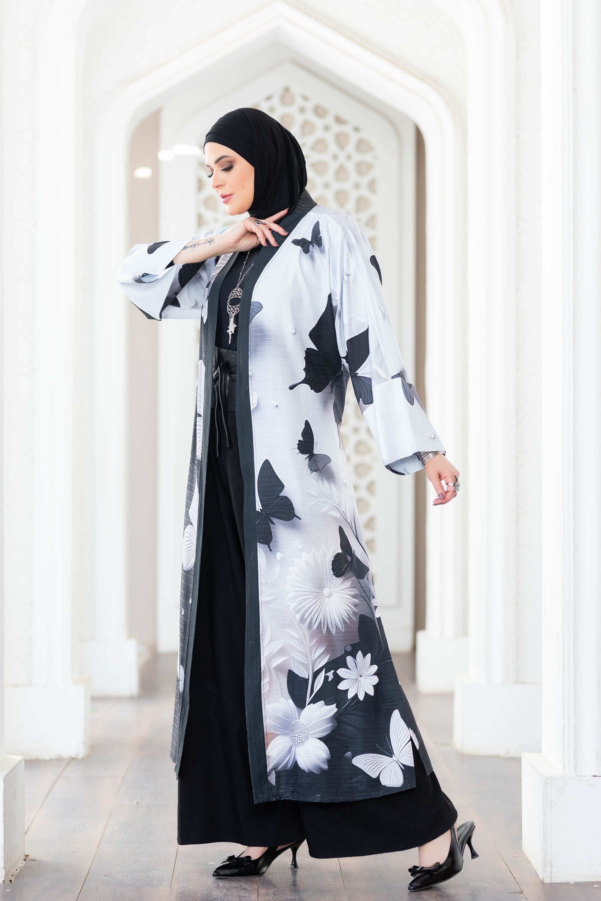 Floral patterned modest kimono for women, featuring long sleeves and stylish black and white design.