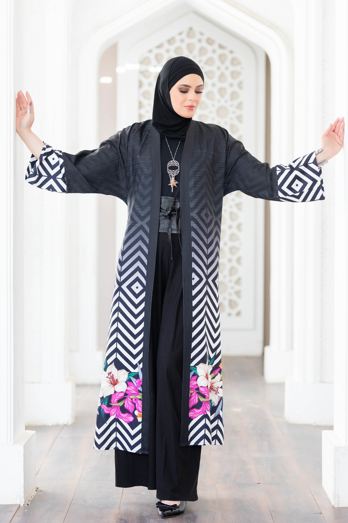 Stylish digital print kimono 777160 with bold chevron patterns and vibrant floral accents, worn by a woman in traditional Islamic attire.
