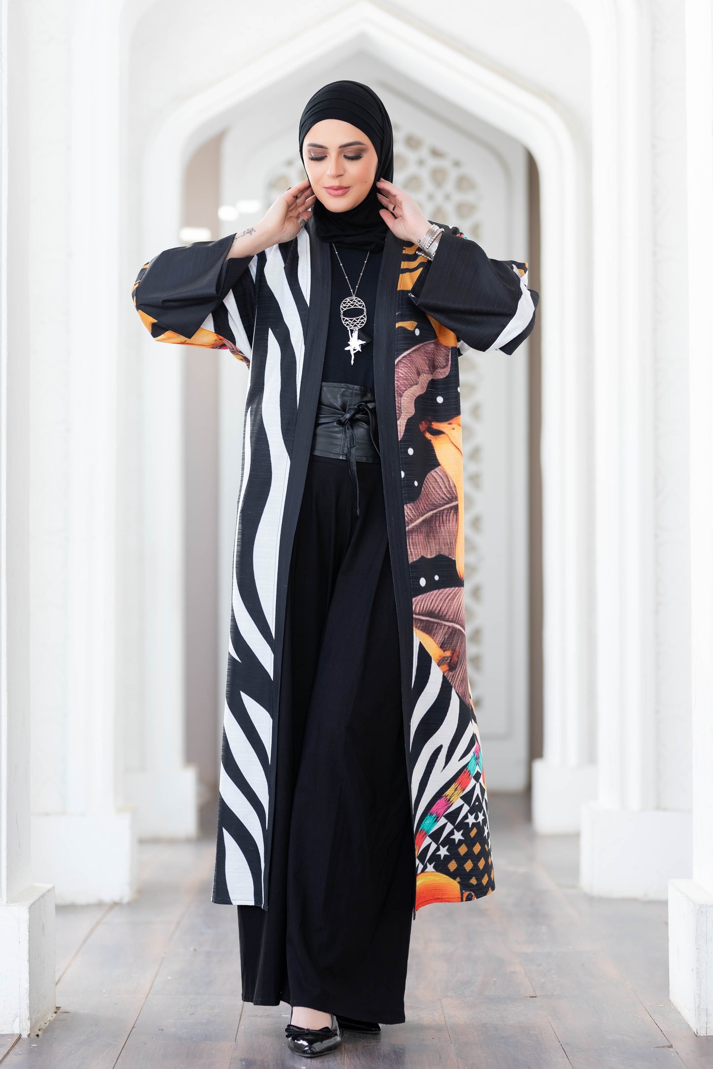 Stylish digital print kimono with bold black and white vertical stripes, vibrant floral accents, and a dramatic long length for a striking look.