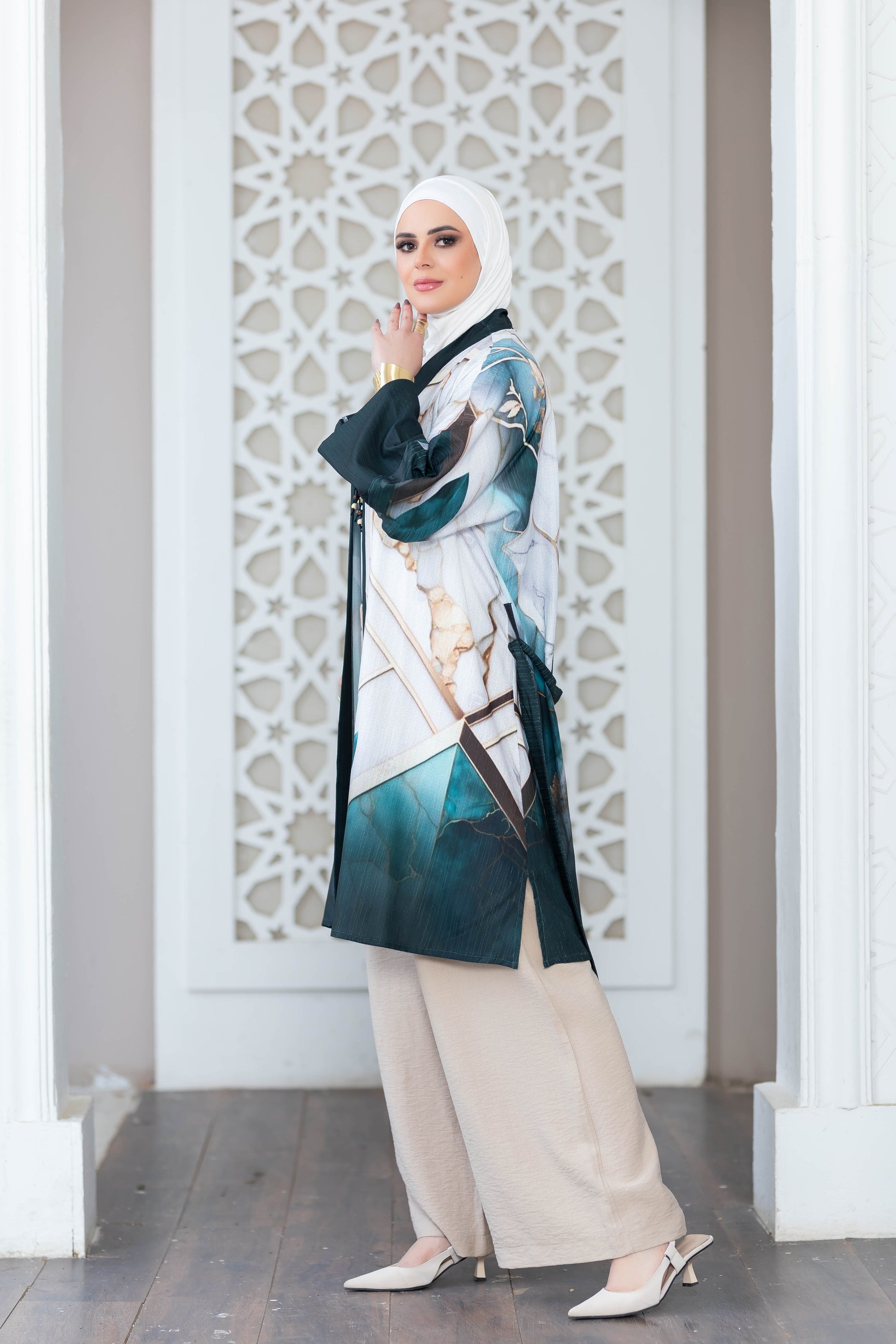 Beautiful flowing digital print kimono from My Store's collection. Elegant hijab and stylish outfit complemented by intricate architectural backdrop.