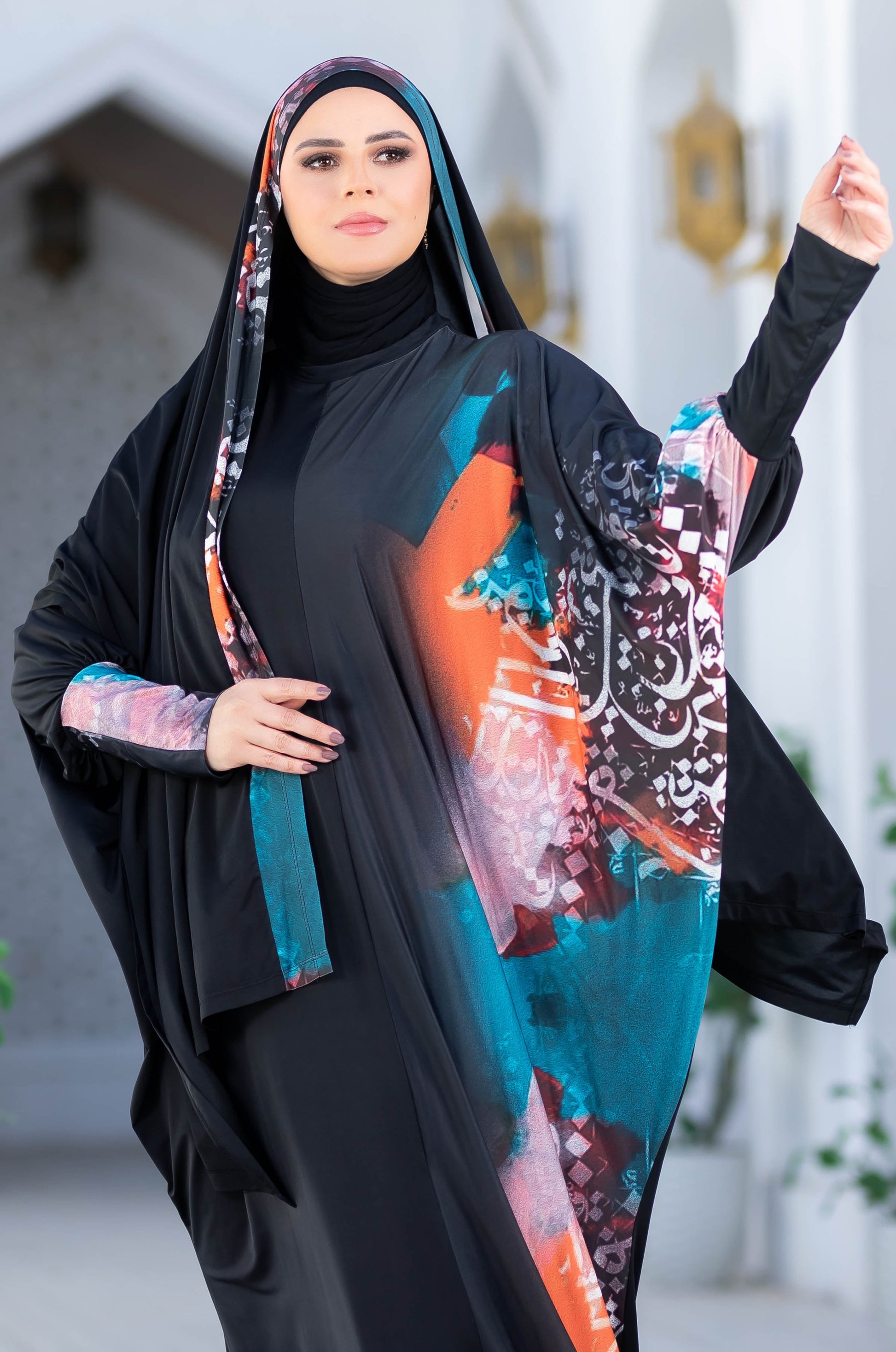 Modest floral-patterned abaya, traditional Islamic attire featuring a long black robe with vibrant floral designs, worn by a woman