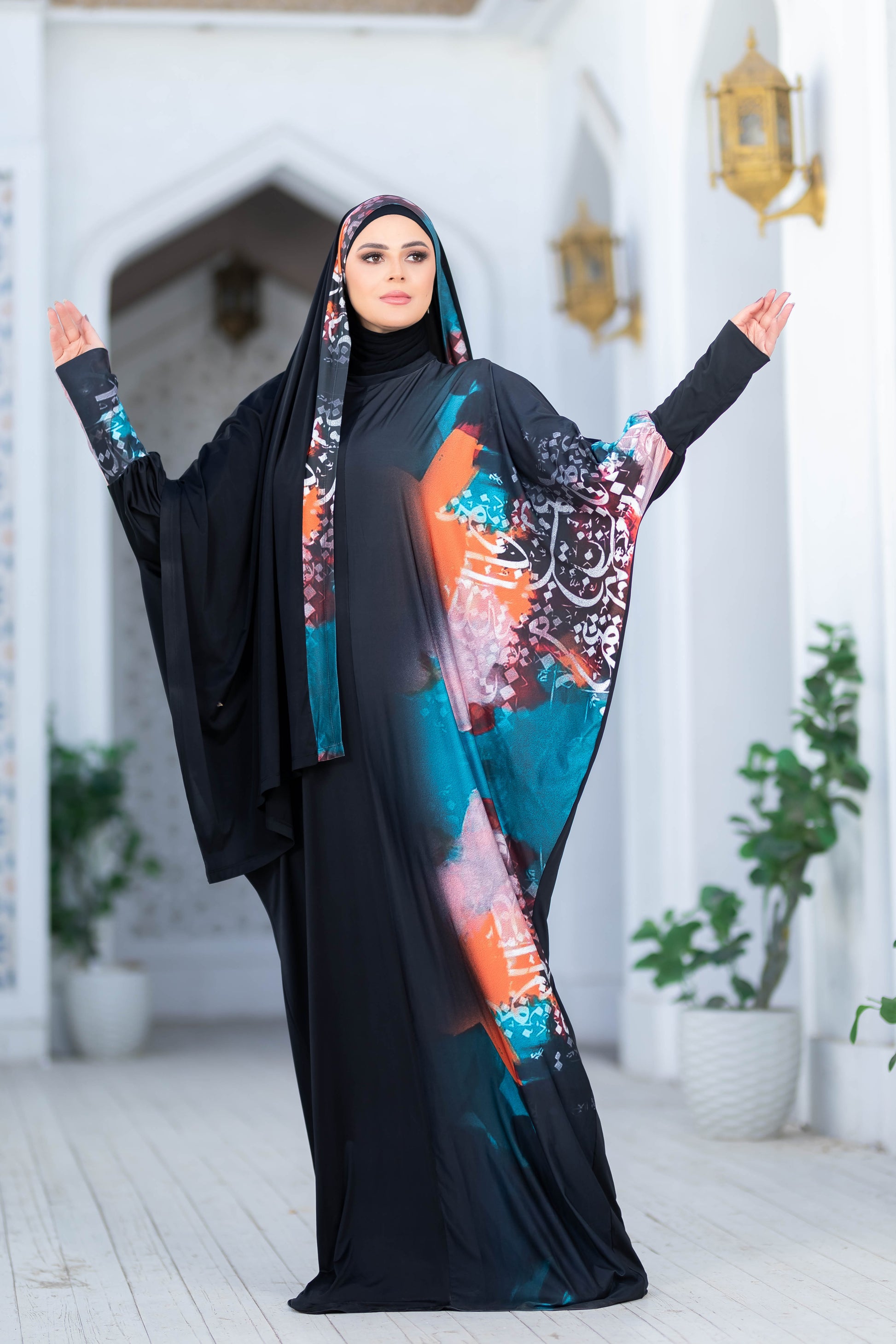 Elegant floral abaya with vibrant patterns, worn by a modest Muslim woman in a traditional setting.