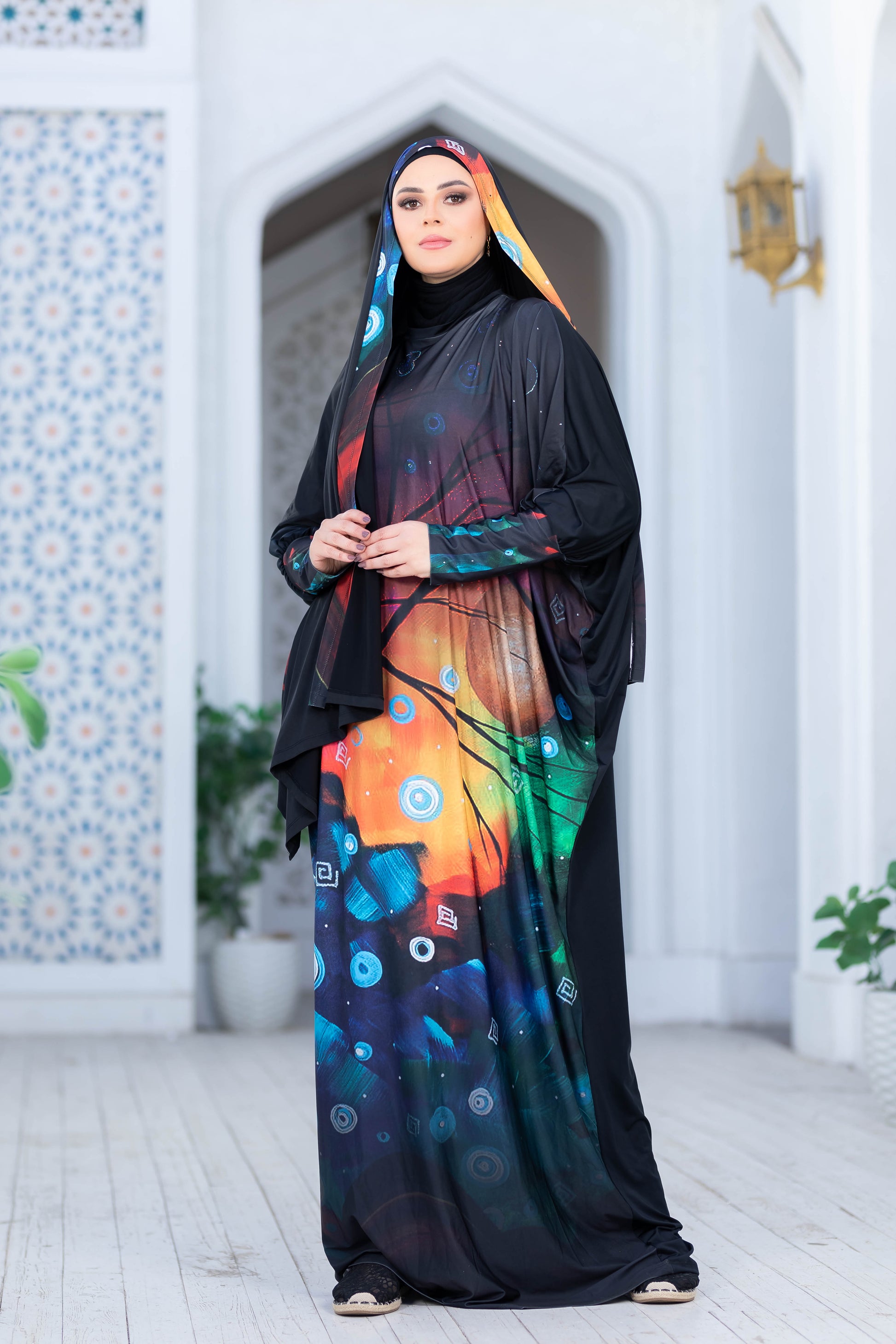 Modest Isdal 77713 by My Store: Colorful and vibrant Islamic abaya with floral patterns, worn by woman standing in traditional architectural setting.