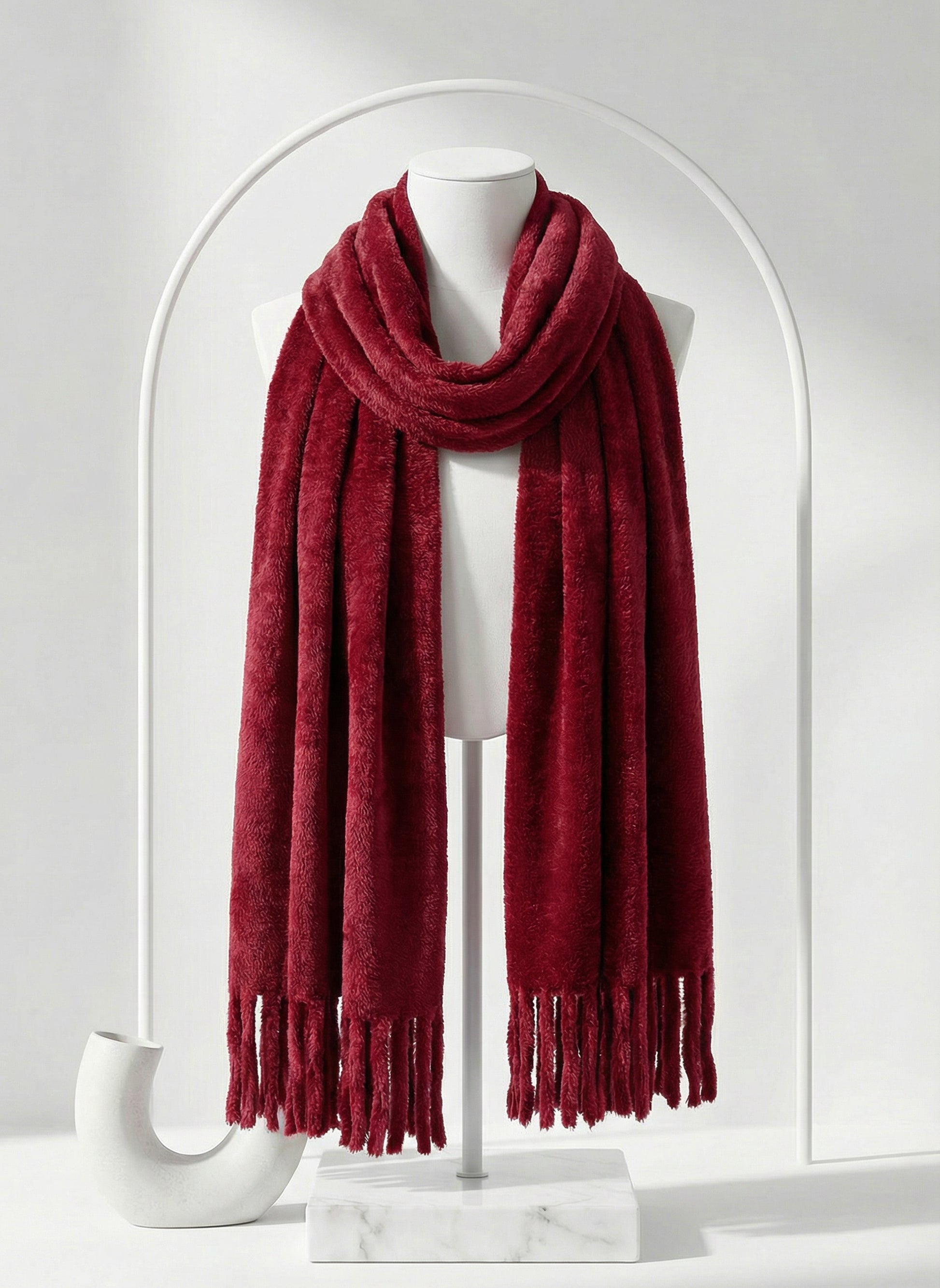 Red scarf on a mannequin against a white background