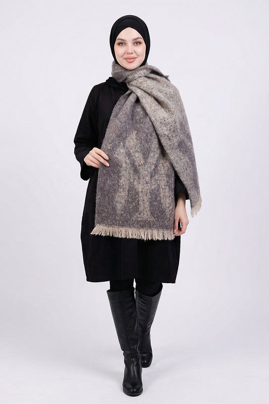 Woman wearing a large gray patterned scarf on a white background