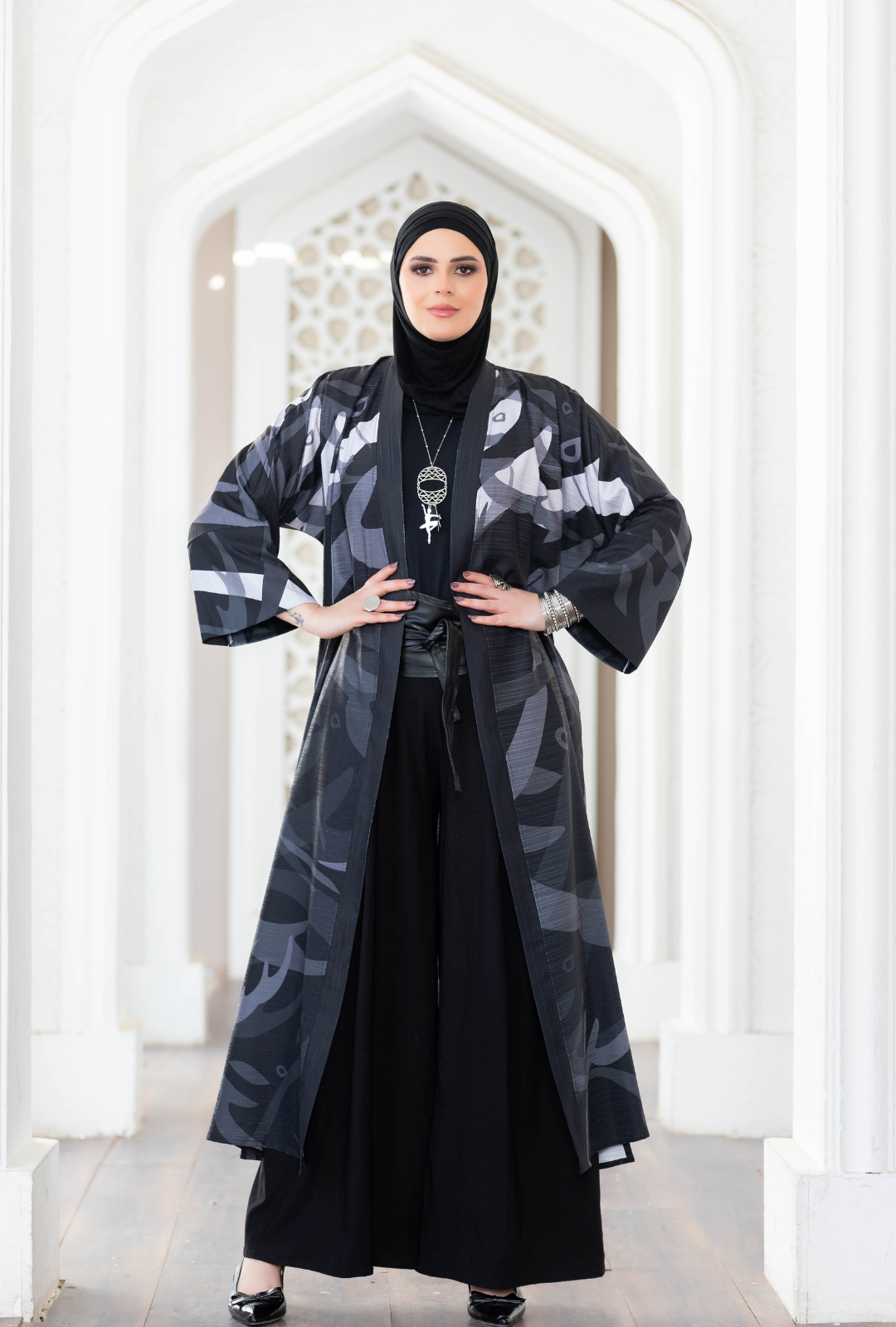 Elegant digital print kimono with a flowing design, worn by a woman in an architectural setting.