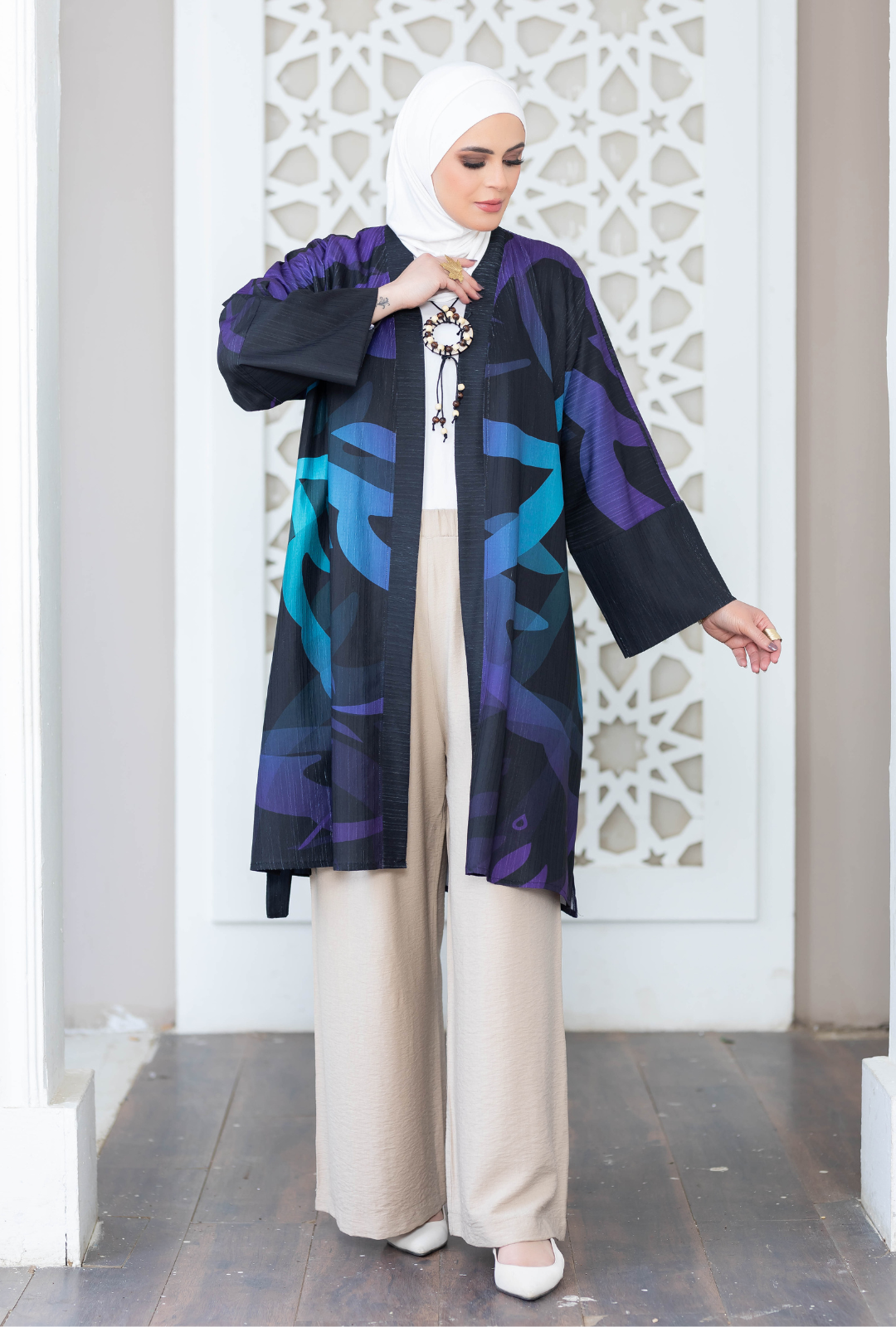 Vibrant digital print kimono with geometric patterns in shades of purple, blue, and black against a white background.