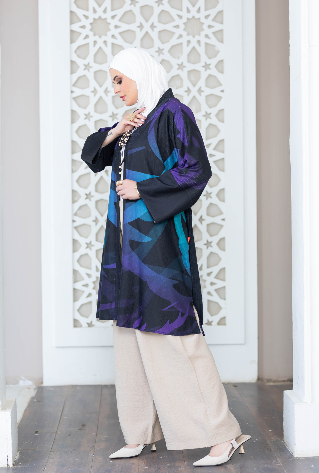 Elegant Islamic fashion: Vibrant patterned kimono, modest hijab, and stylish footwear.