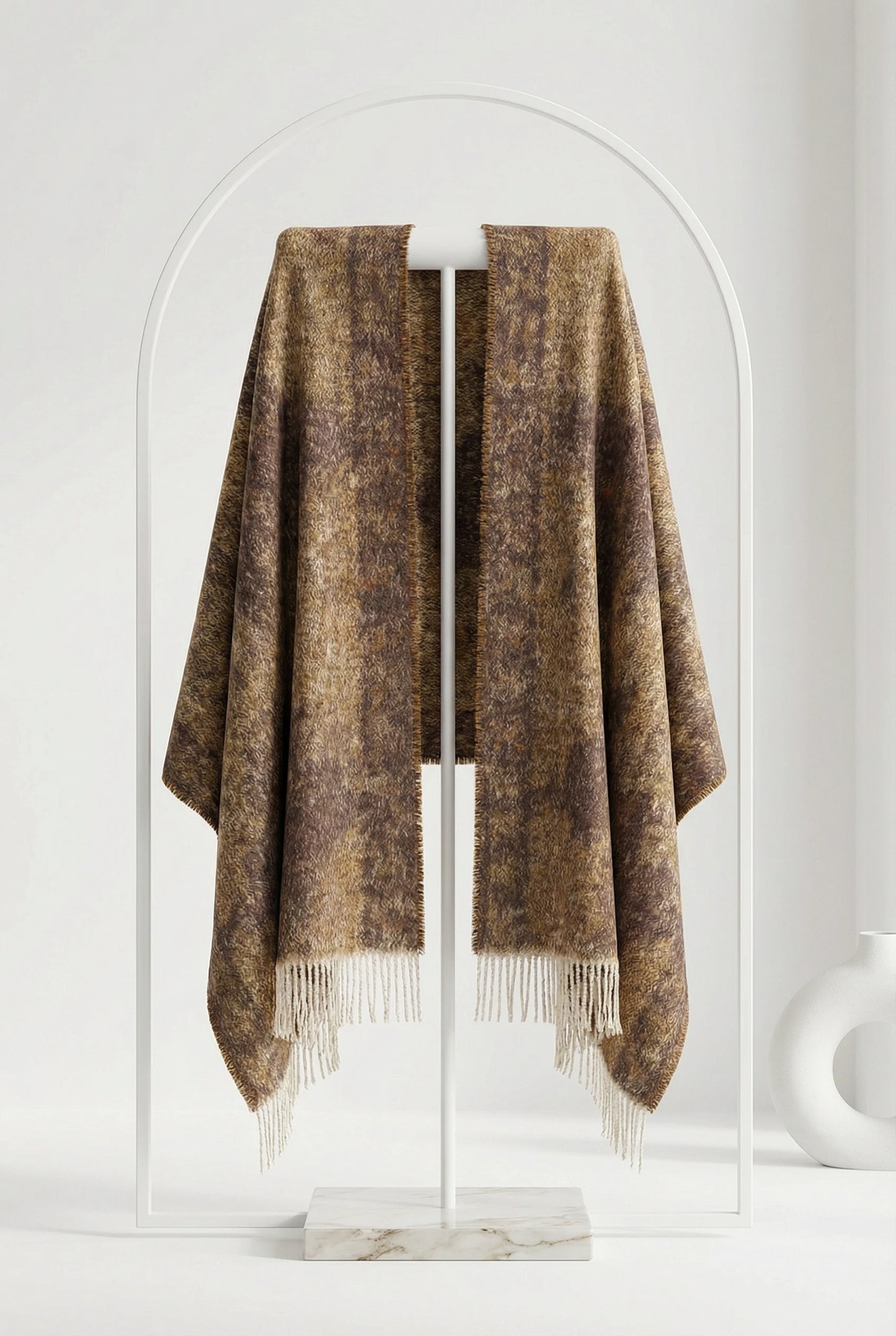 Brown plaid blanket draped over a white rack against a white background
