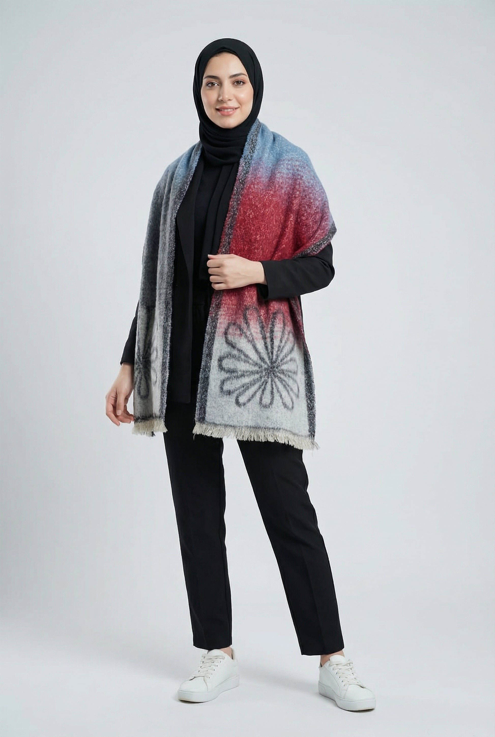 Woman wearing a patterned scarf on a white background