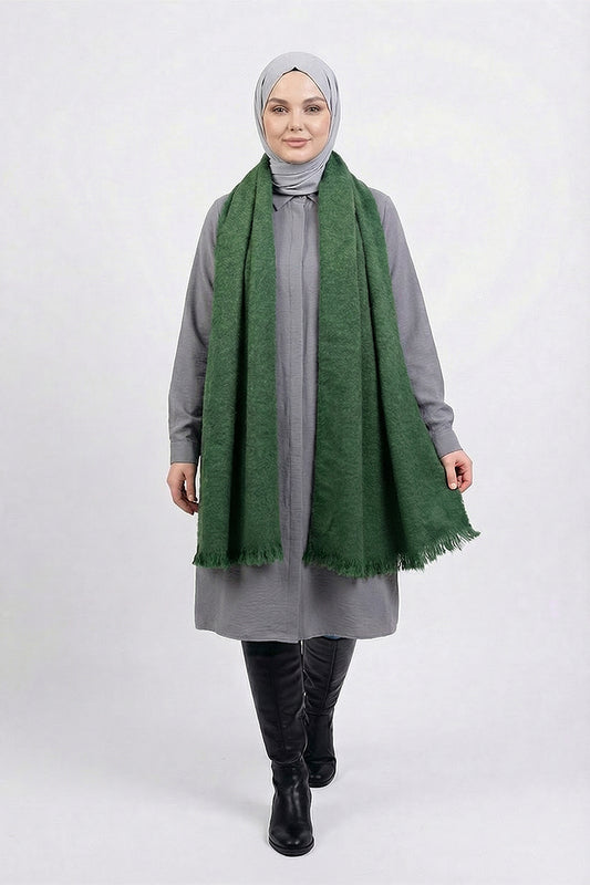 Woman wearing a green scarf and gray outfit on a white background