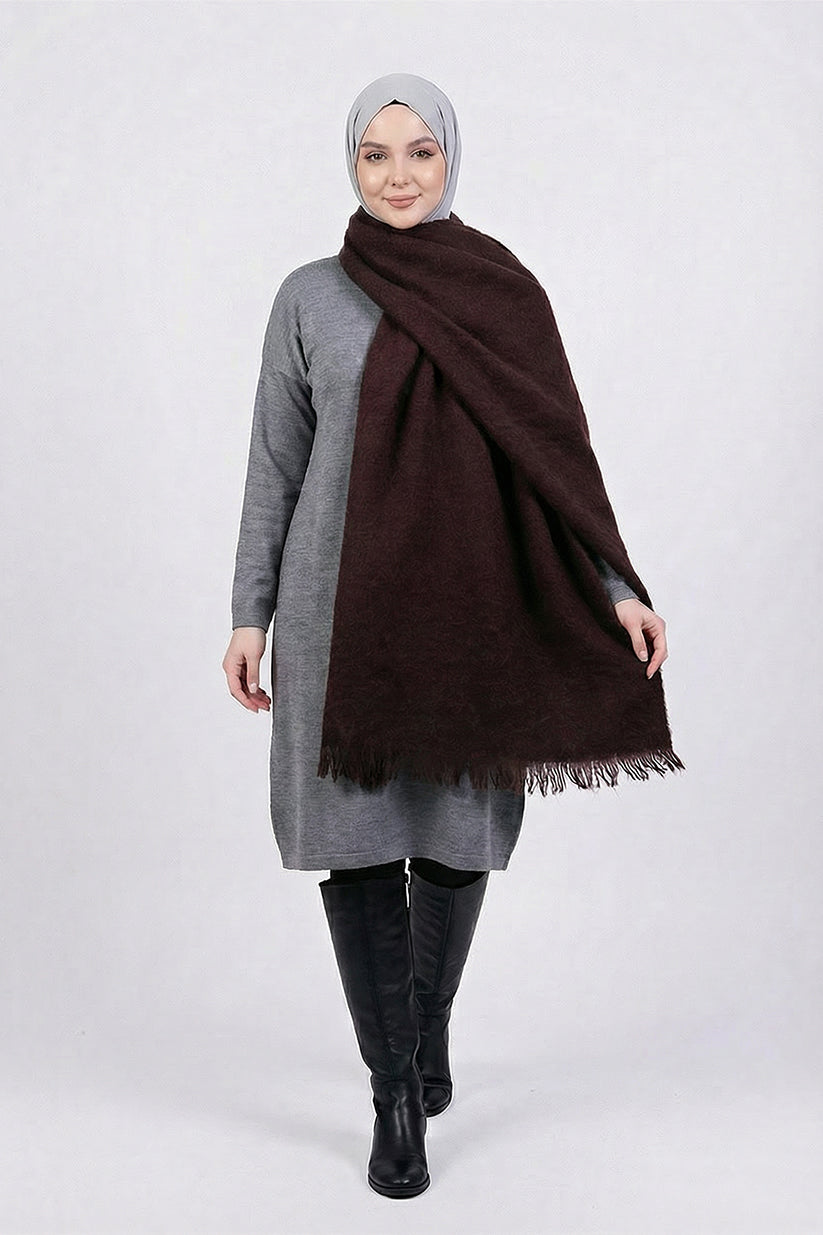 Woman wearing a gray outfit with a brown scarf on a white background