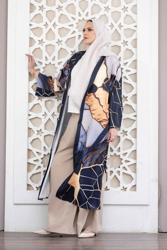 Elegant digital print kimono with abstract pattern and flowing sleeves, displayed against a decorative white architectural frame.