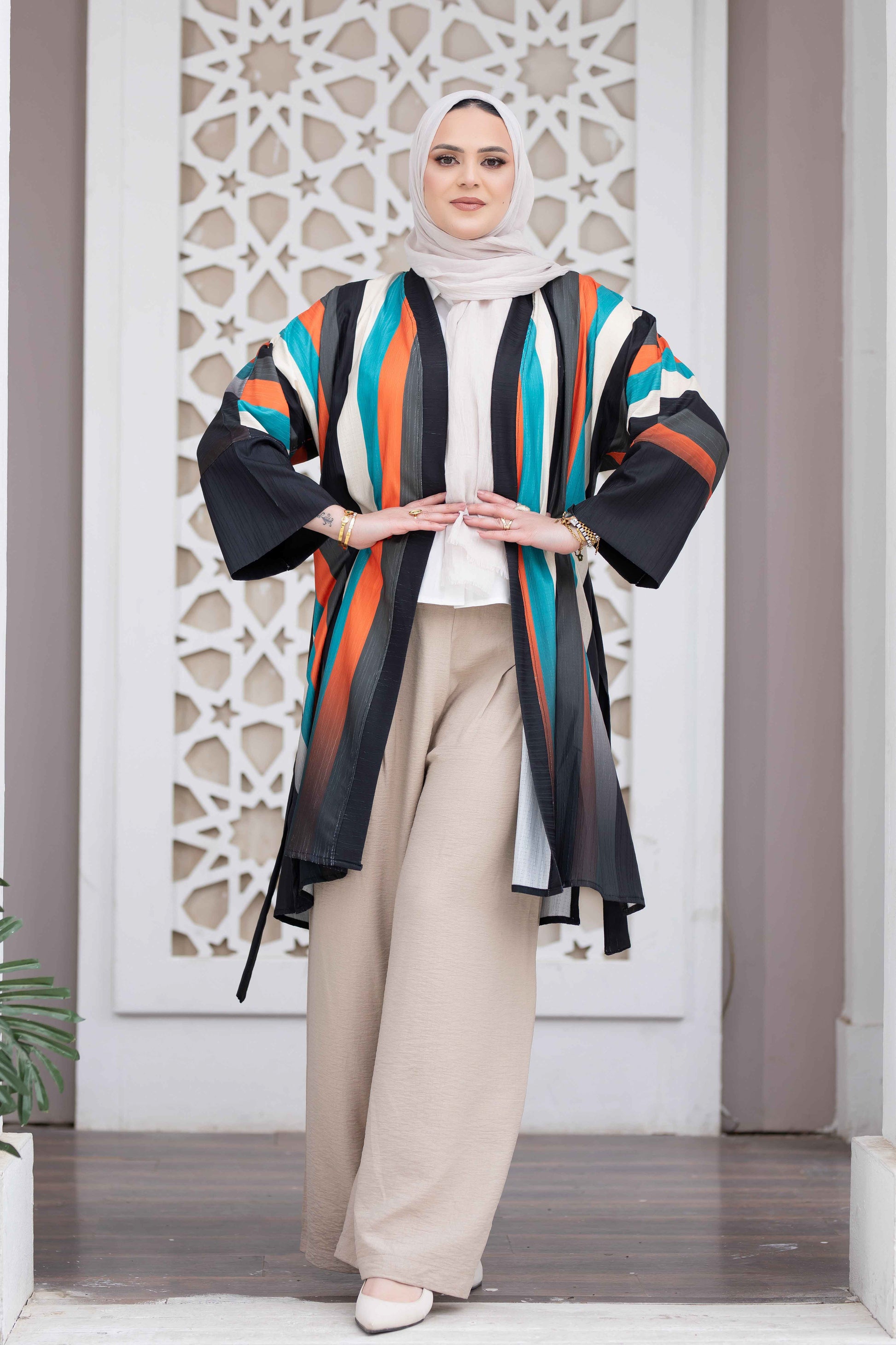 Vibrant colored long jacket with Islamic architectural background