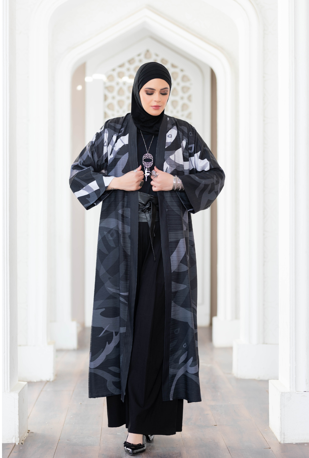 Stylish abstract print kimono worn by woman in traditional Islamic dress.