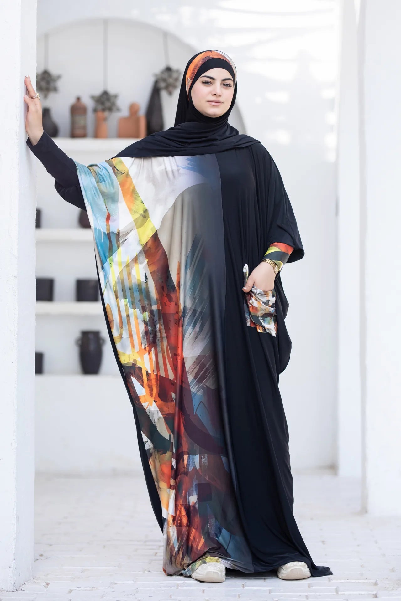 Model wearing statement isdal with bold colors and modern modest elegance
