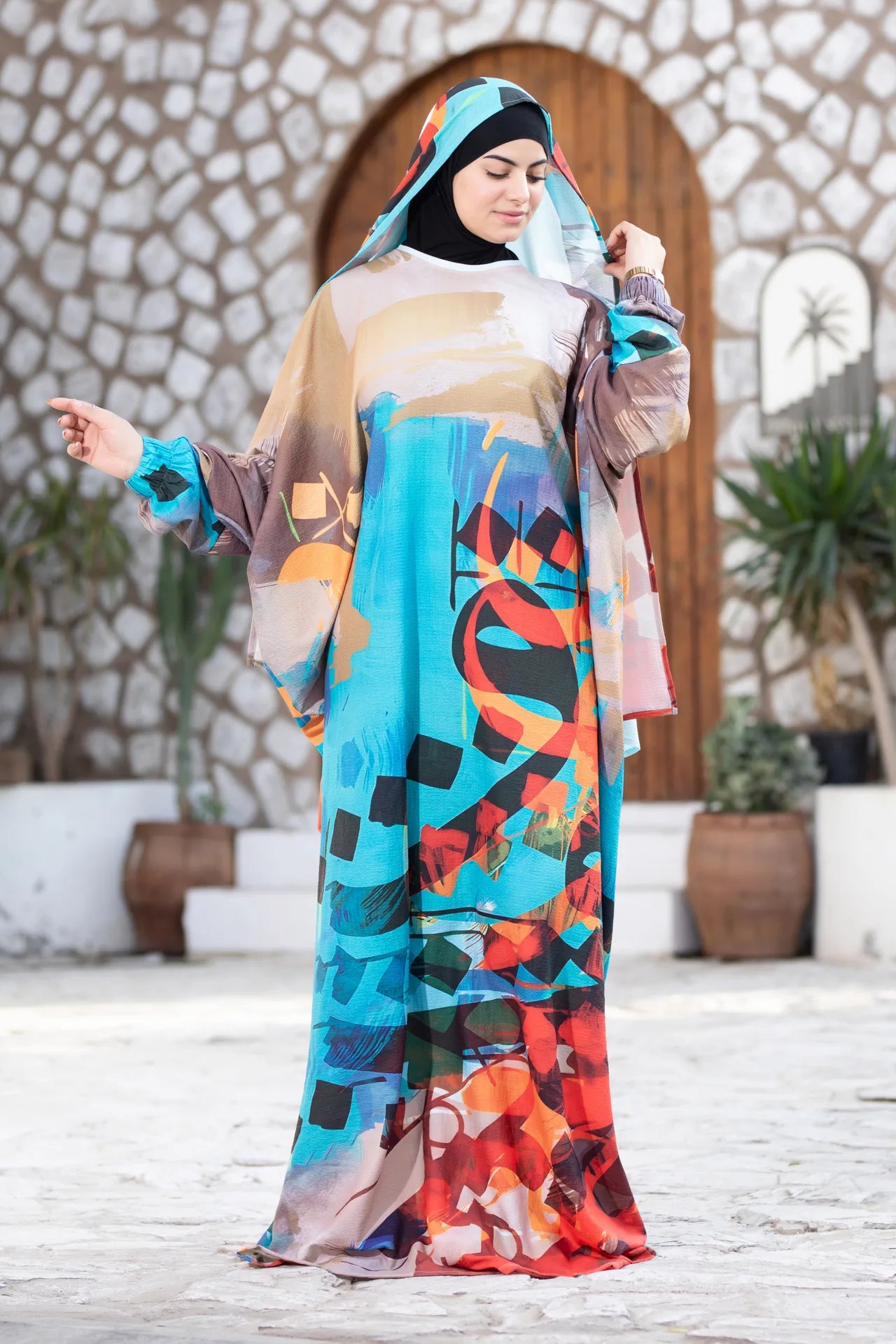 Mawj flowing statement garment with artistic print and bold color transitions
