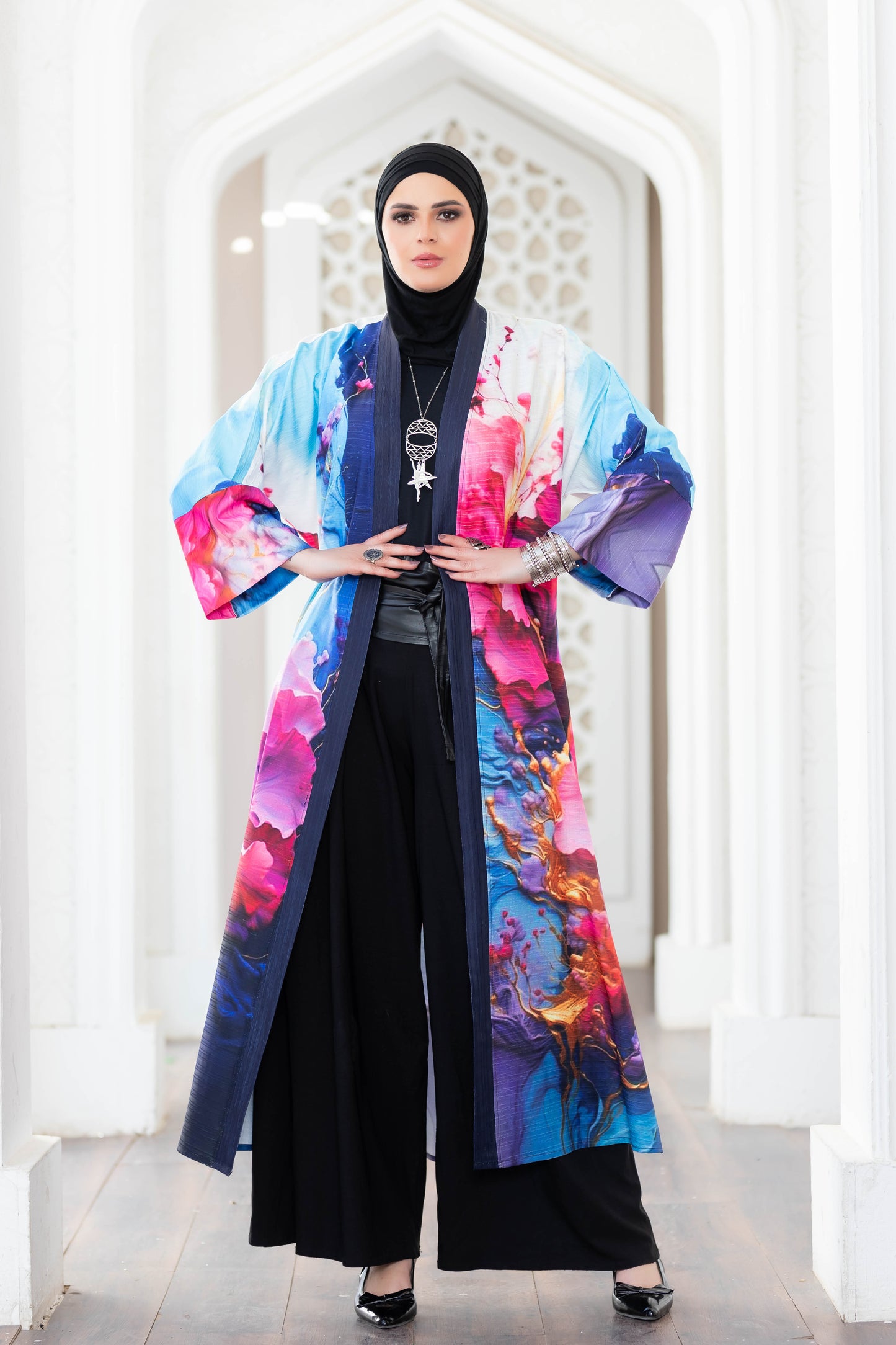 Colorful floral kimono-style outerwear with vibrant, abstract patterns against a plain white background.