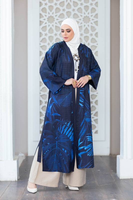 Digital print navy blue kimono with floral patterns, worn by a woman with a hijab standing in front of a white tile wall.