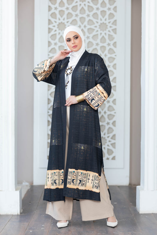 Beautiful black floral print kimono with ornate pattern detail on satr clothing store display.