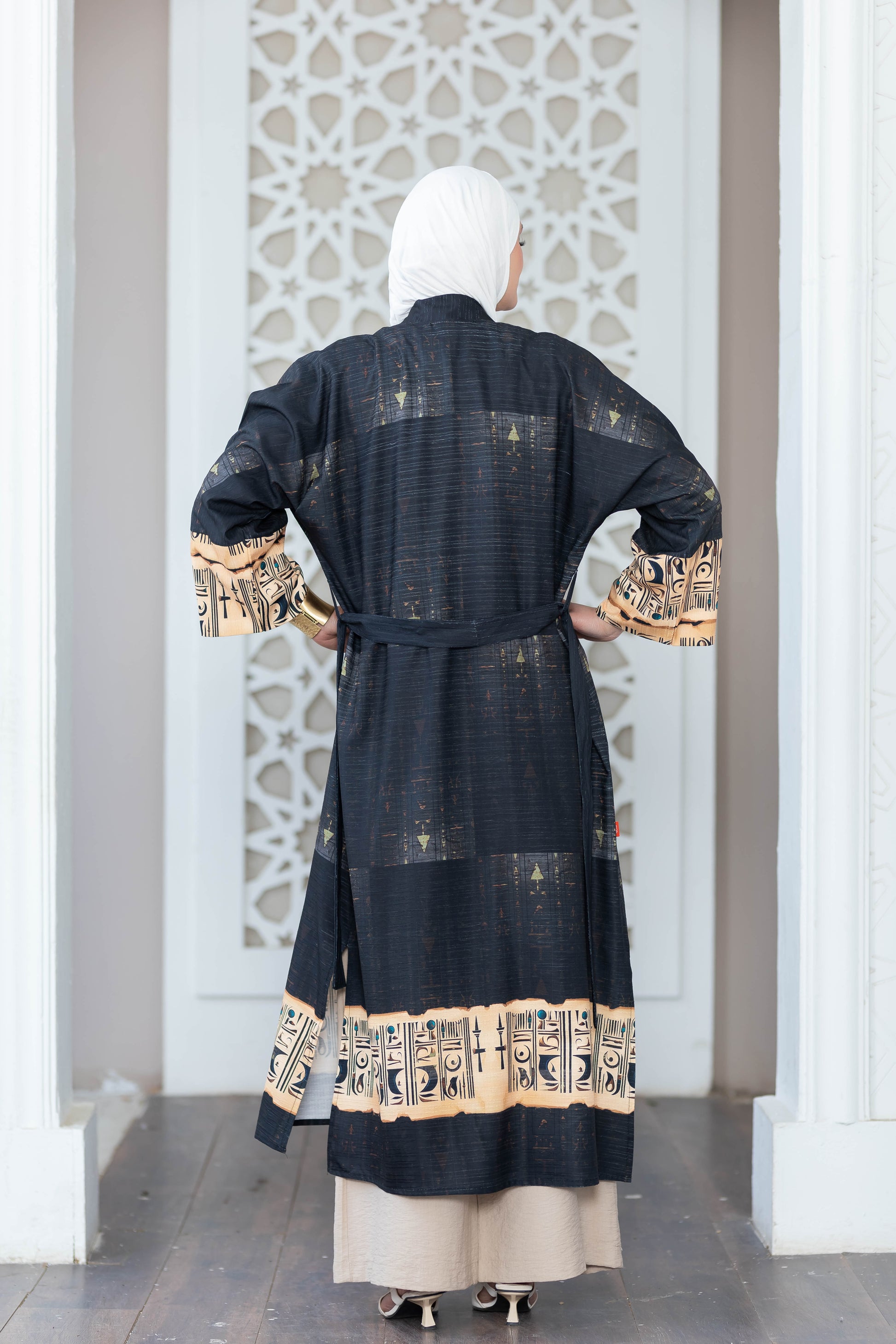 Elegant black and beige digital print kimono with intricate patterns and details, displayed against a white geometric background.