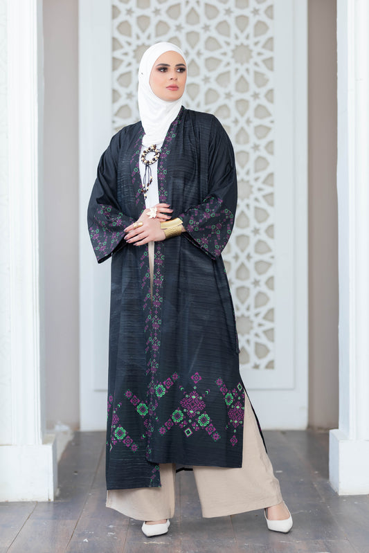 Elegant floral print kimono with flowing sleeves and modest design, worn by a woman standing in front of a decorative white wall.