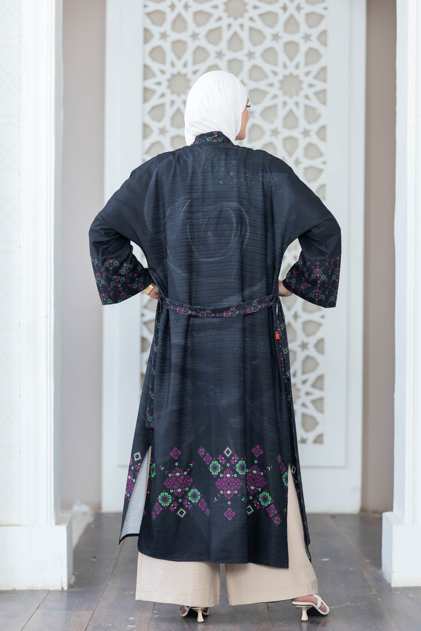 Ornate black digital print kimono with intricate floral designs, worn over white background.