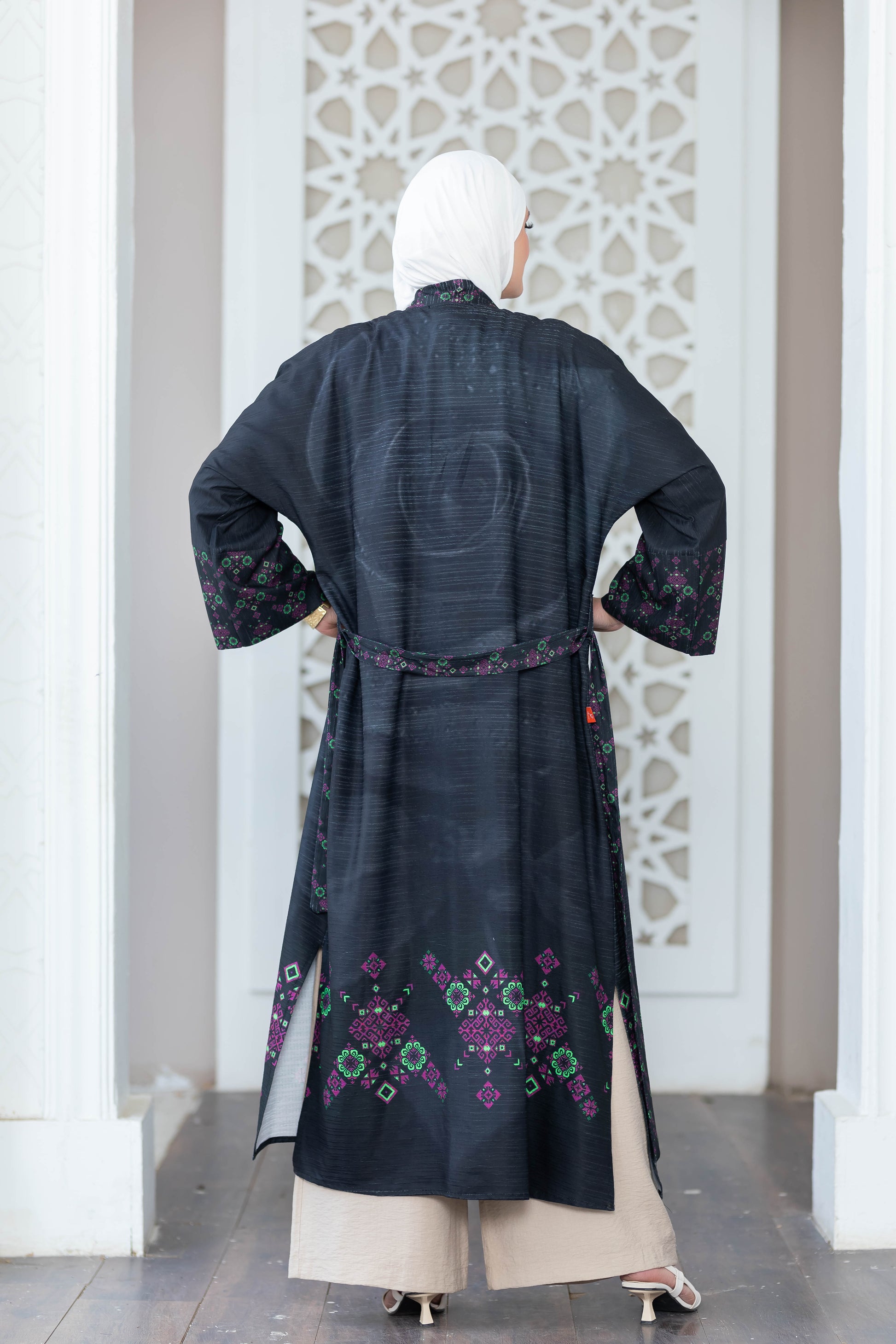 Ornate black digital print kimono with intricate floral designs, worn over white background.