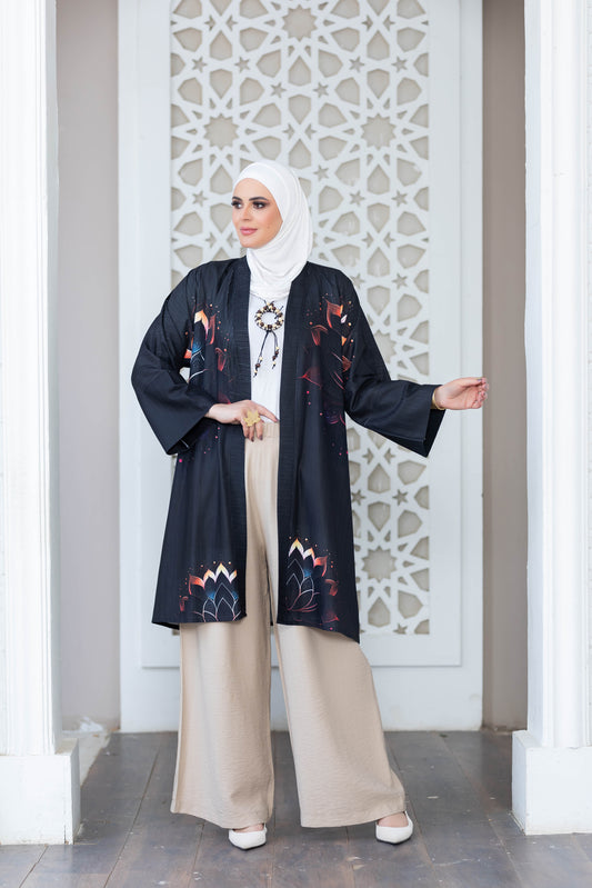 Elegant long kimono with floral digital print, worn by a woman against a modern architectural background.