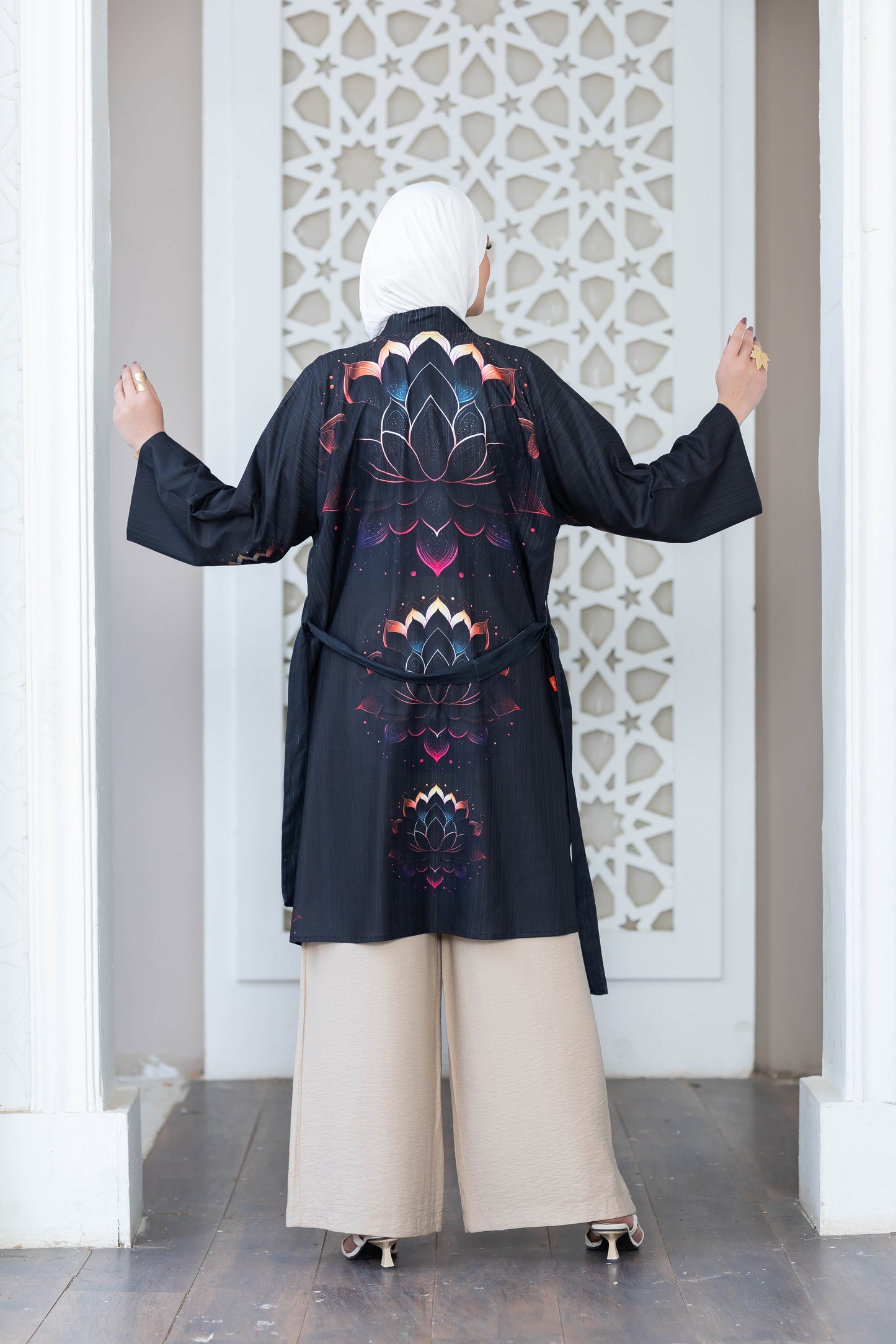 Stylish floral printed short kimono with intricate design, worn elegantly by a person in front of an ornate architectural backdrop.