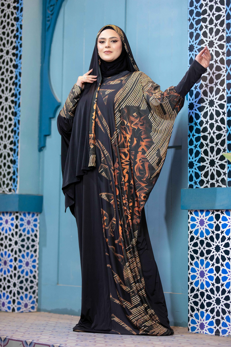 Elegant Islamic dress with patterned abaya, hijab, and ornate decor