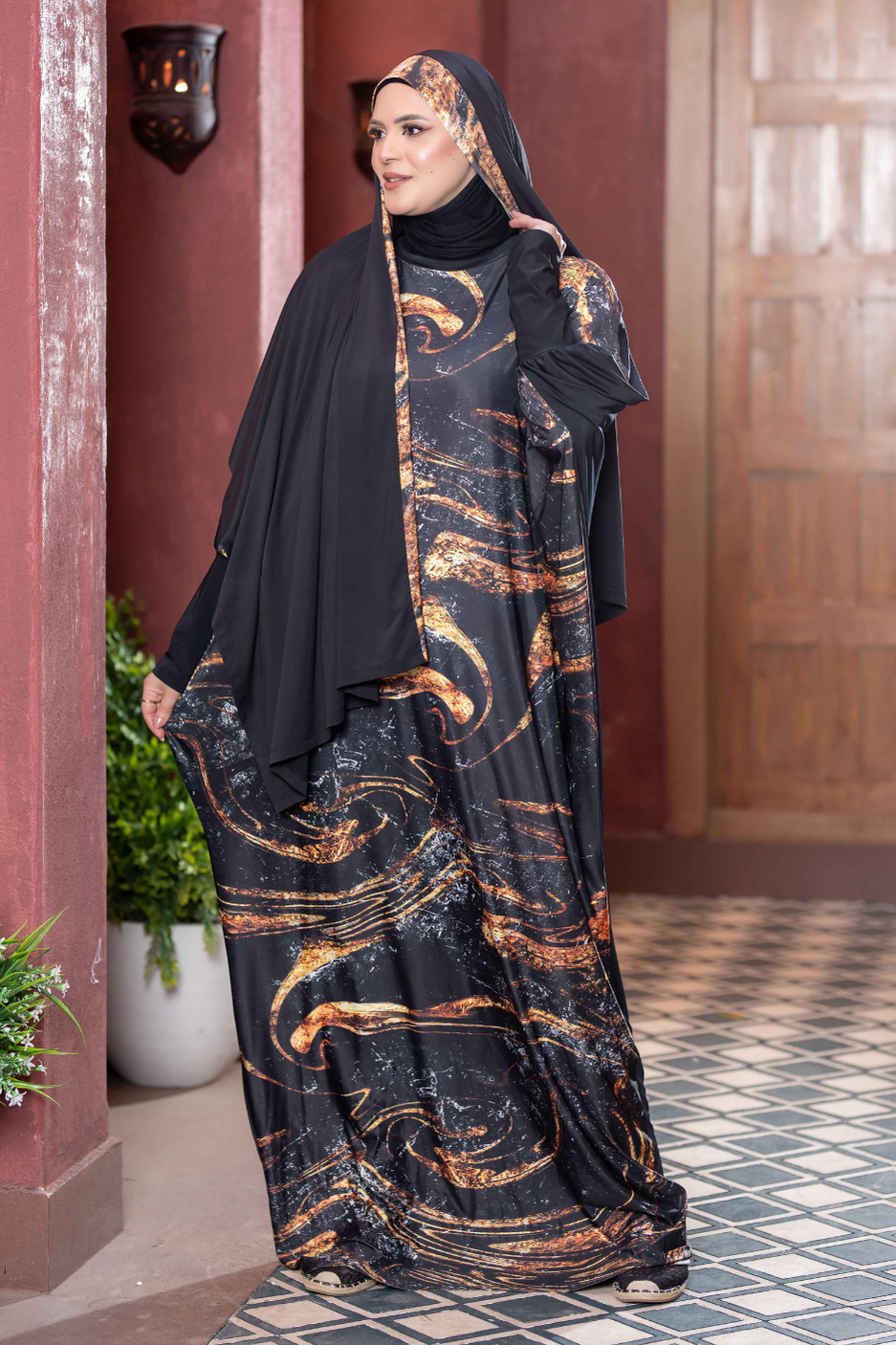 Beautiful black and gold patterned Satr Hejab 77782 dress worn by woman in traditional Middle Eastern attire