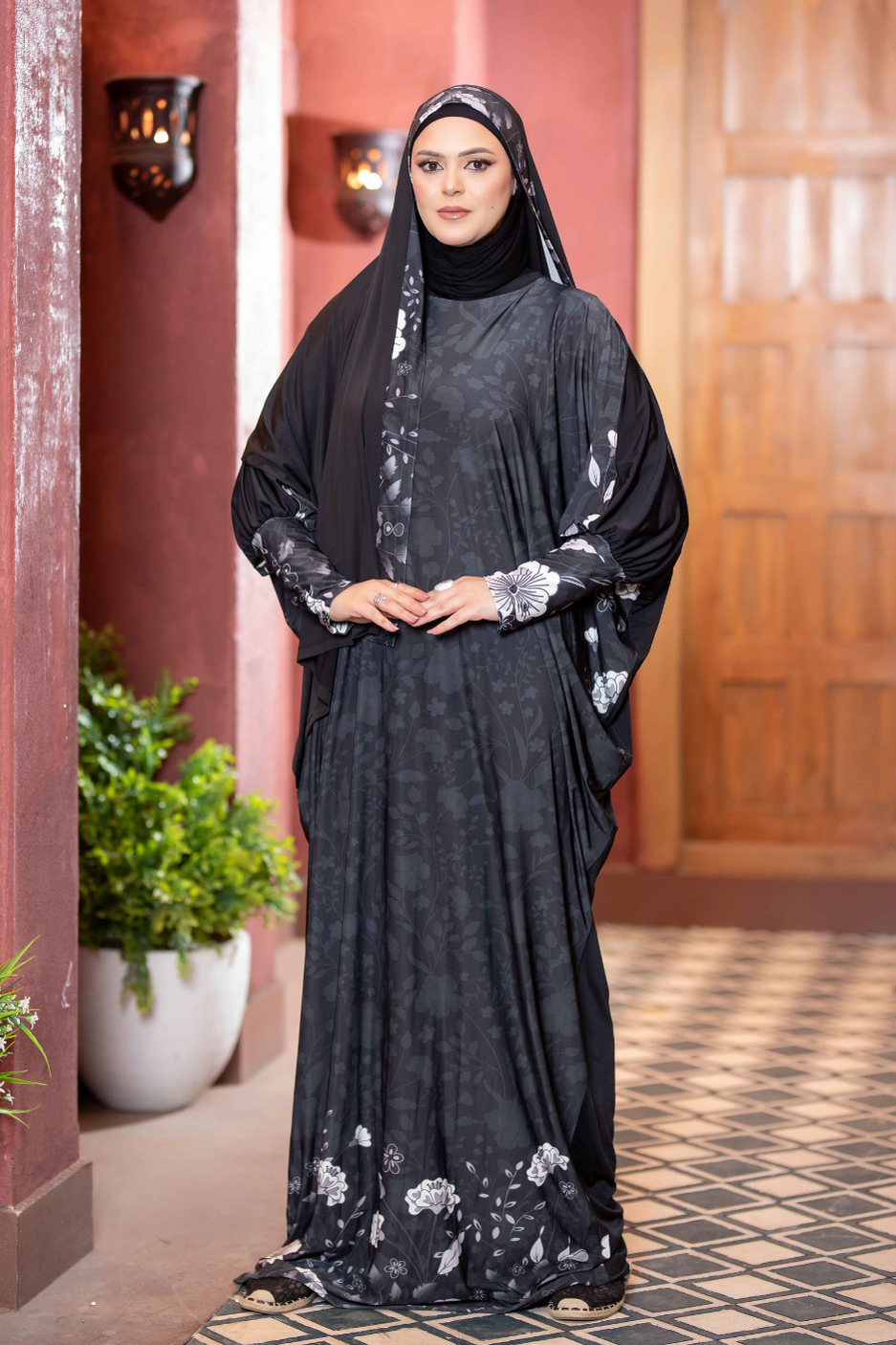 Elegant Satr Hejab 77776: Modest floral-patterned Islamic dress with hijab, showcased in a traditional setting.