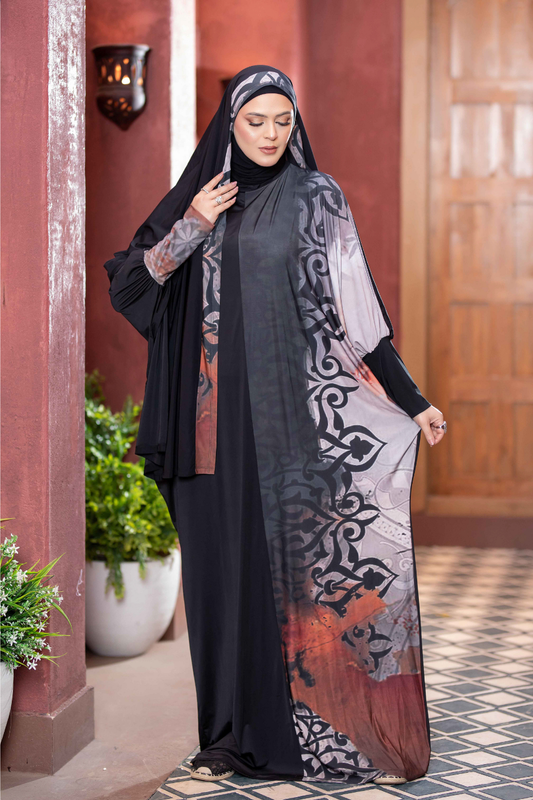 Elegant Islamic dress with ornate pattern, black hijab, traditional Middle Eastern fashion, woman standing outside traditional building