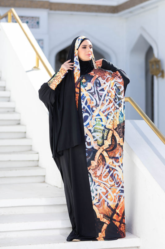 Modest Isdal 777141 ESDAL from My Store - Colorful traditional print dress with black abaya, worn by a woman standing on stairs.