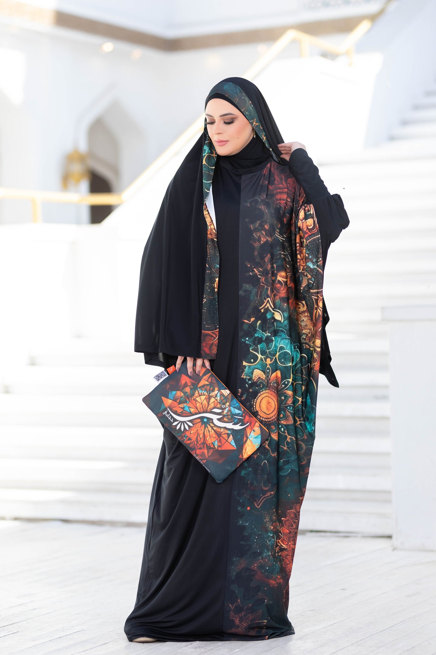 Modest Isdal 777172 ESDAL dress with vibrant floral print and black abaya worn by woman in image.