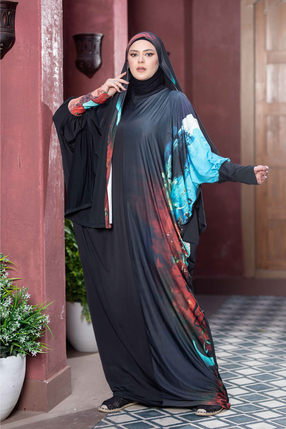 Satr Hejab 777178 - Elegant Islamic dress with vibrant floral design, modest headscarf, and graceful pose against pink wall.