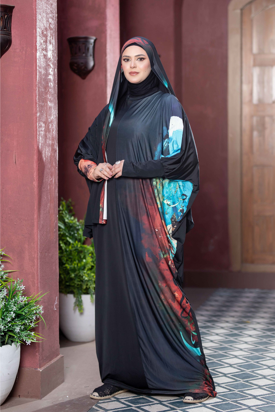 Satr Hejab 777178 ESDAL, Traditional Islamic woman's dress in elegant black and turquoise colors, Woman standing gracefully in doorway.