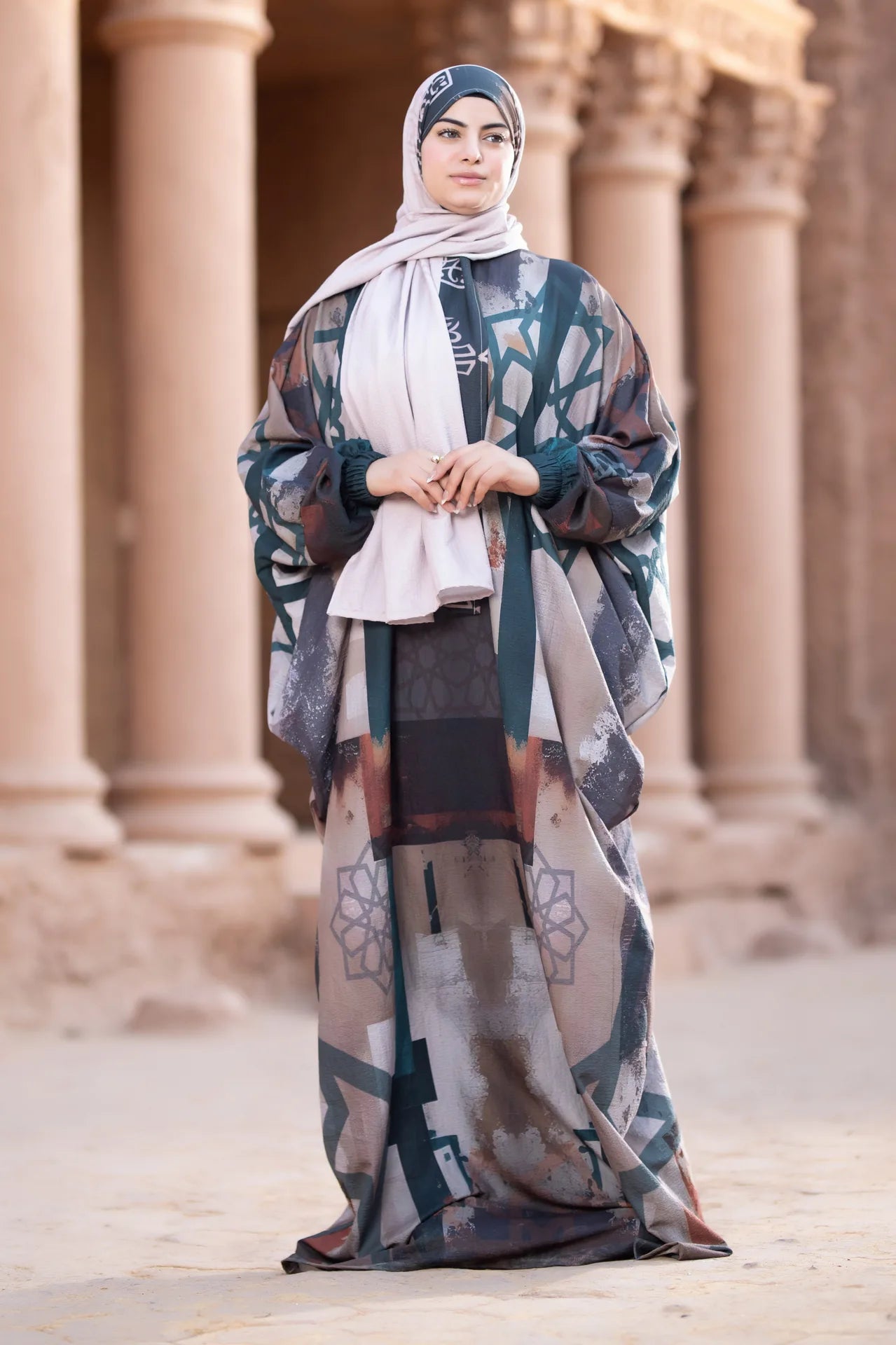 Woman in a patterned dress standing in front of classical architecture